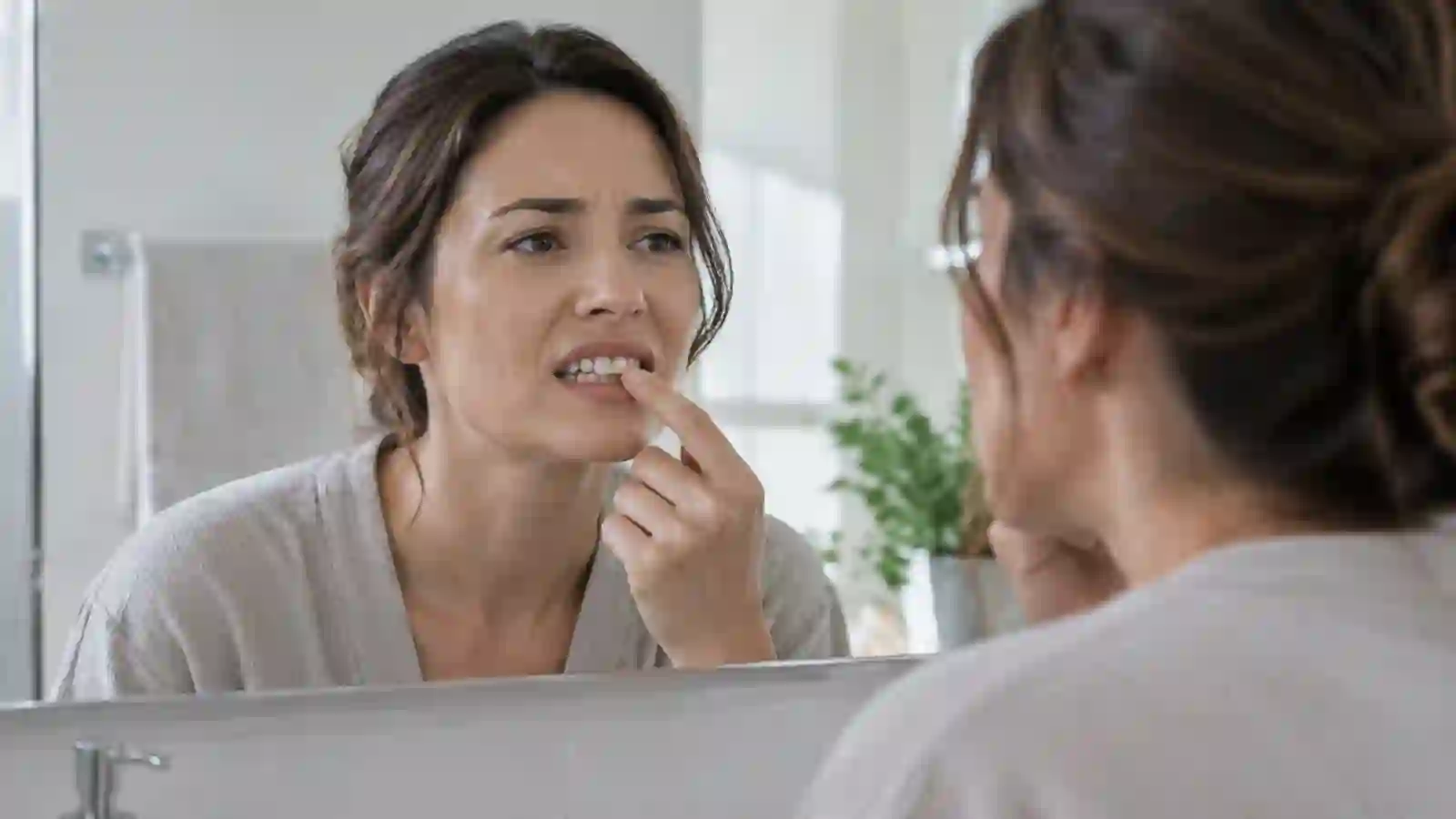 Persona adulta preocupada por un diente que se mueve Persona adulta preocupada por un diente que se mueve